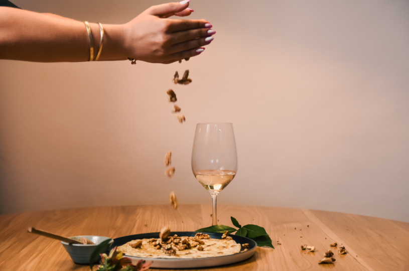 Traditional Sfakiani pie with goat cheese, honey and walnuts with a glass of Muscat of Spina P.G.I. Crete