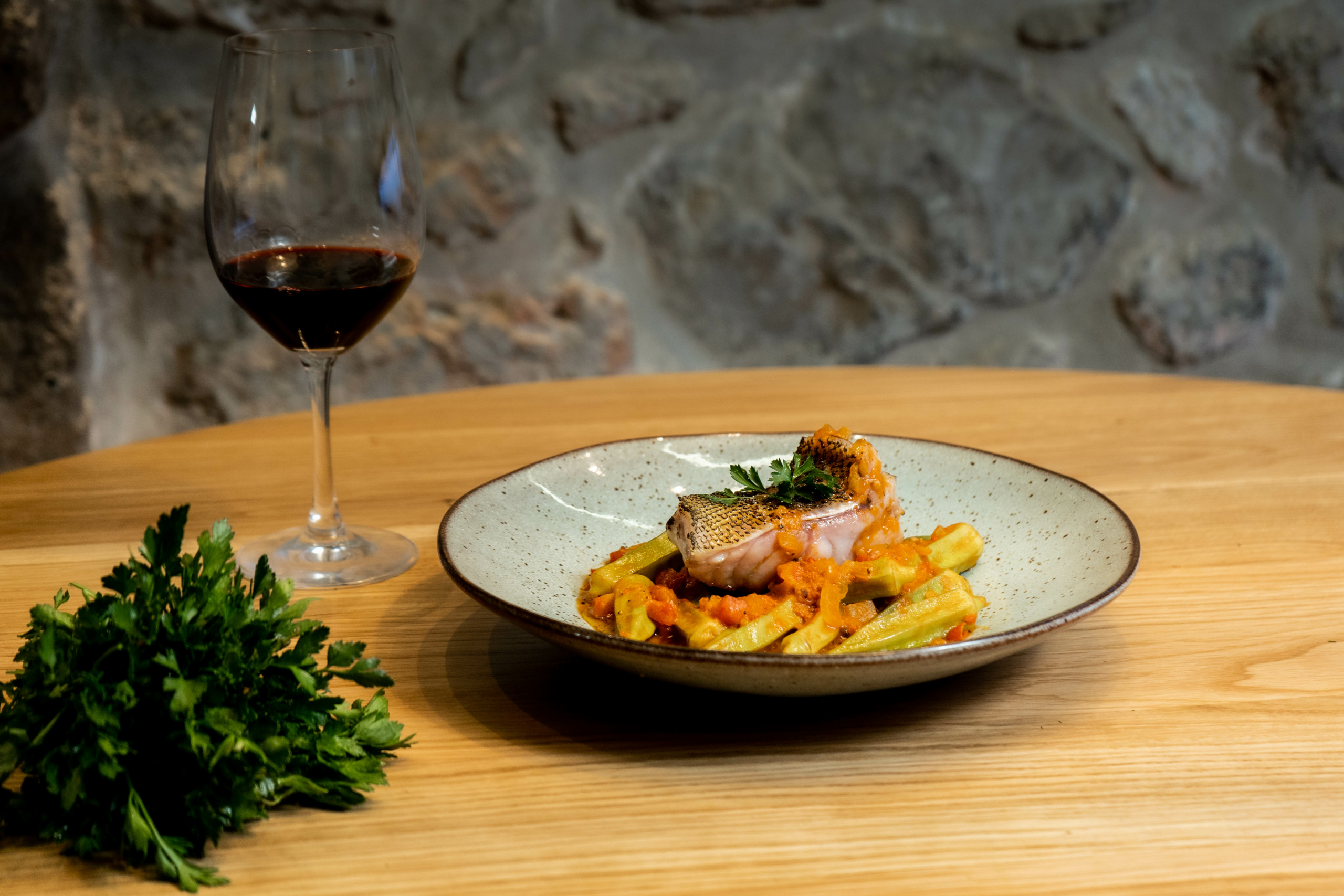 Dusky grouper with okras with a glass of Kotsifali P.G.I. Crete