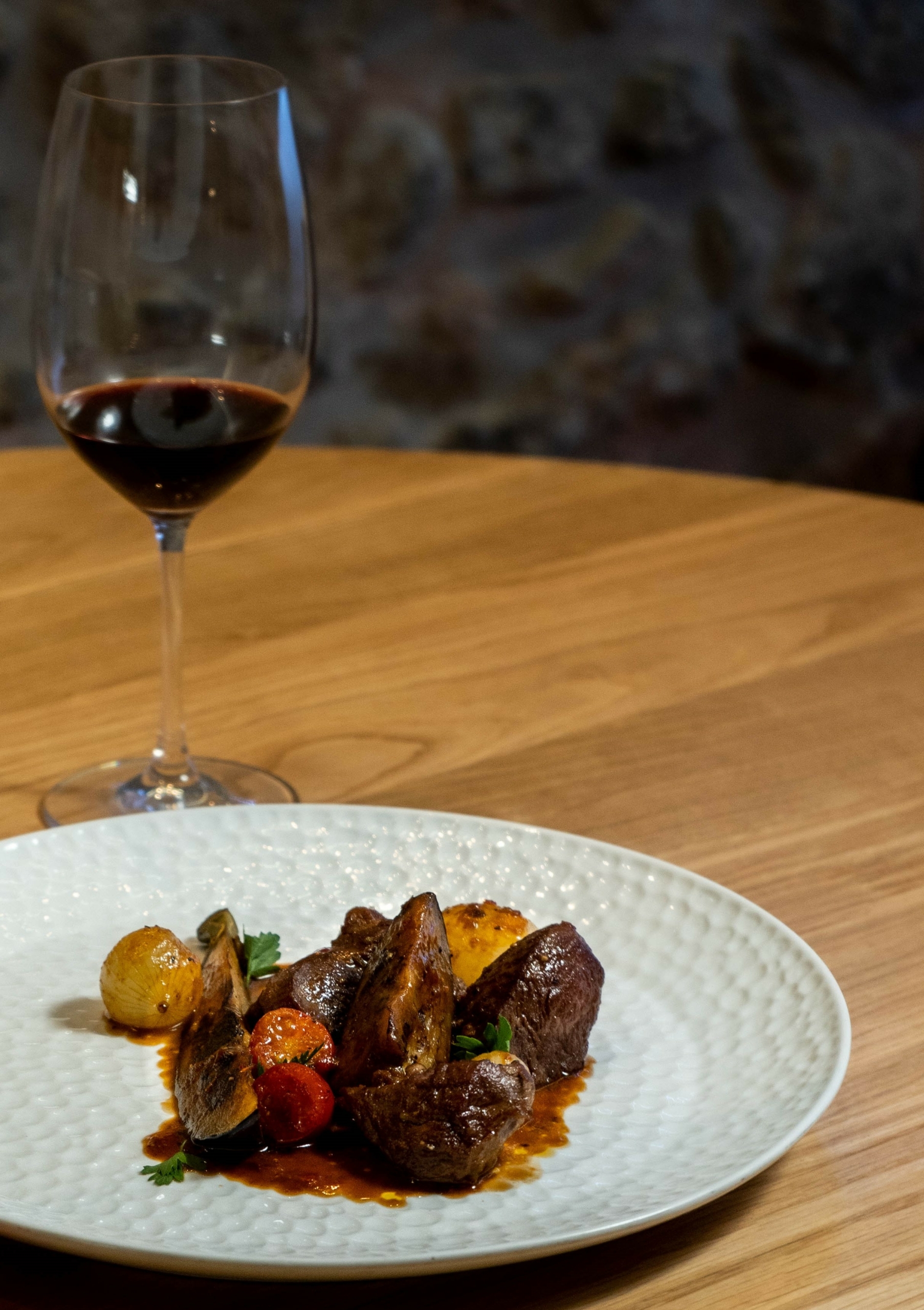 Beef and eggplant braised with tomato sauce with a glass of Mandilari P.G.I. Crete | Wines of Crete