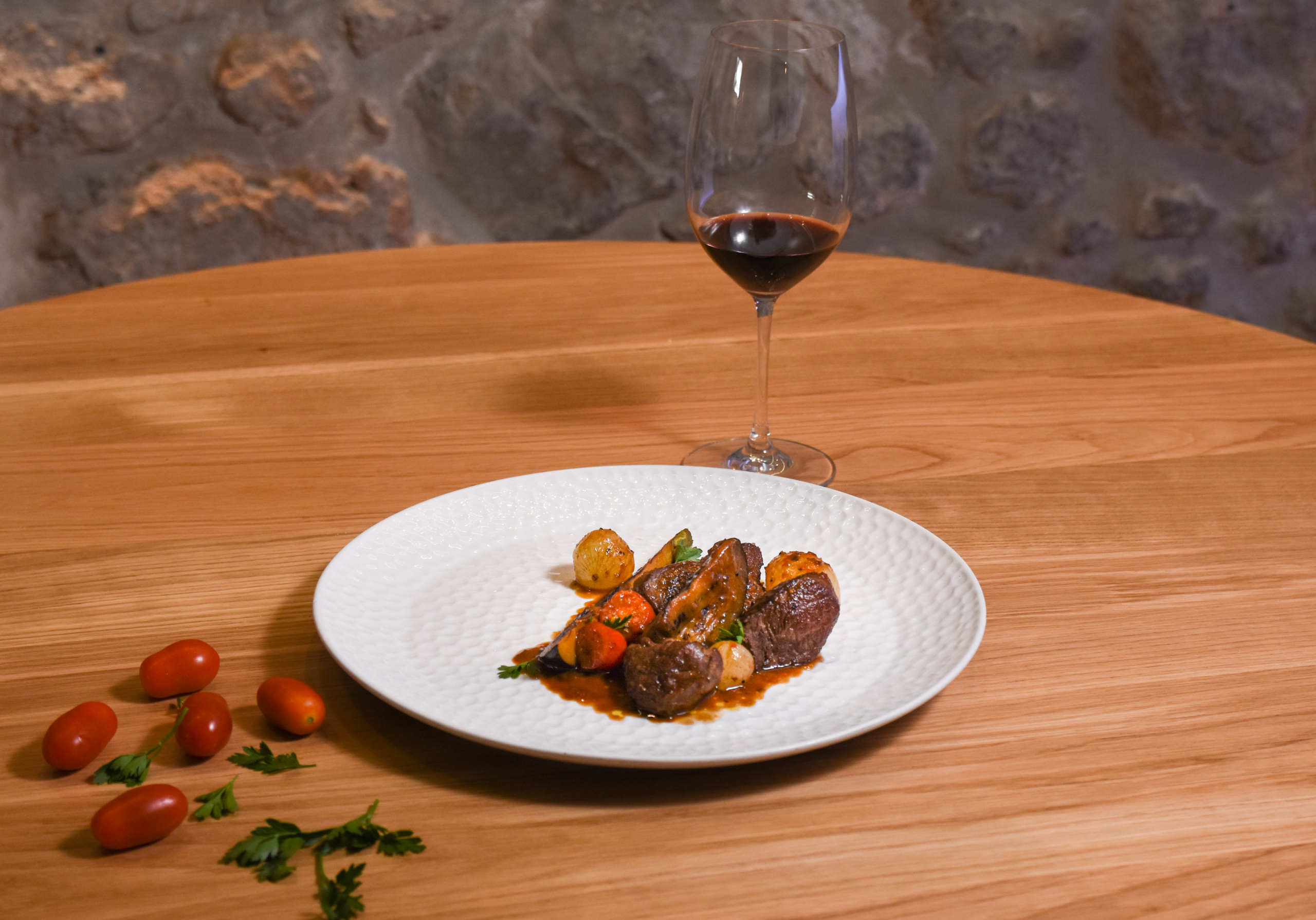 Beef and eggplant braised with tomato sauce with a glass of Mandilari P.G.I. Crete