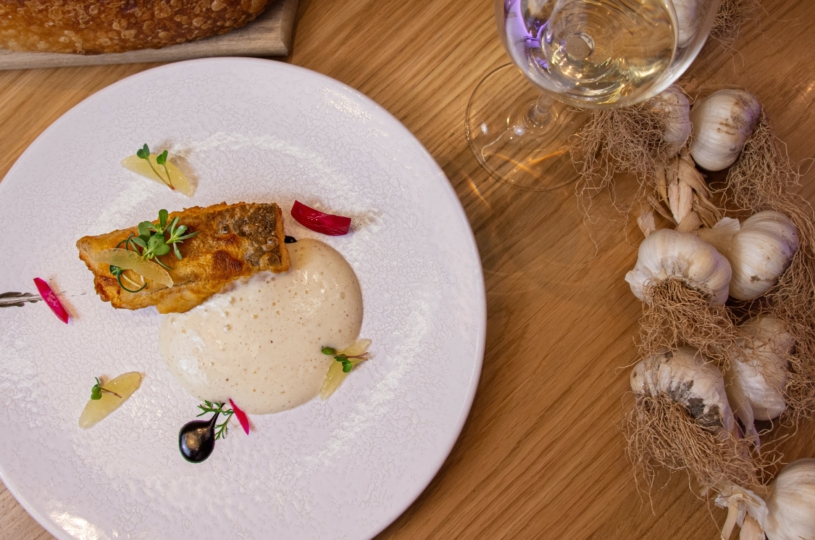 Fried cod with potato cream and black garlic paste with a glass of Malvazia di Candia P.G.I. Crete