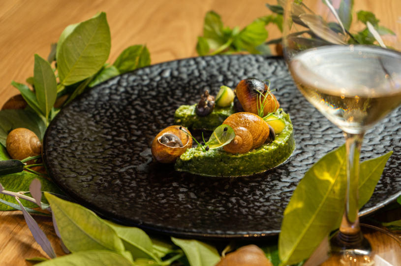 Snails with xinohontros (cracked wheat and barley with fermented milk) and herbal cream with a glass of DafniP.G.I. Crete